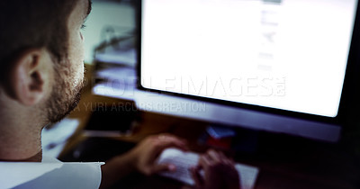 Buy stock photo High angle shot of a handsome young businessman working late in the office
