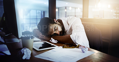 Buy stock photo Cropped shot of a handsome young man sleeping at his desk while working late in the office