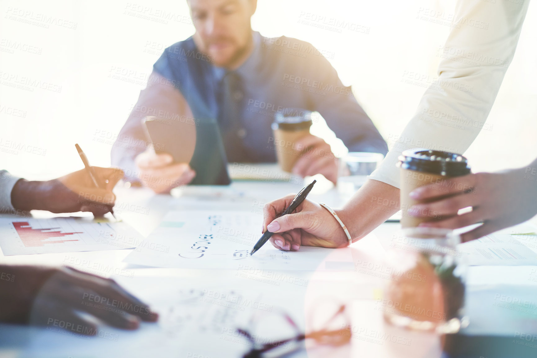 Buy stock photo Cropped shot of unrecognizable businesspeople working together in an office