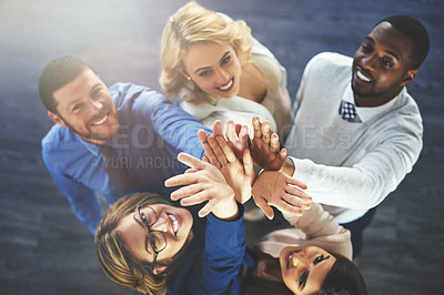 Buy stock photo High angle shot of a group of businesspeople reaching for a high five