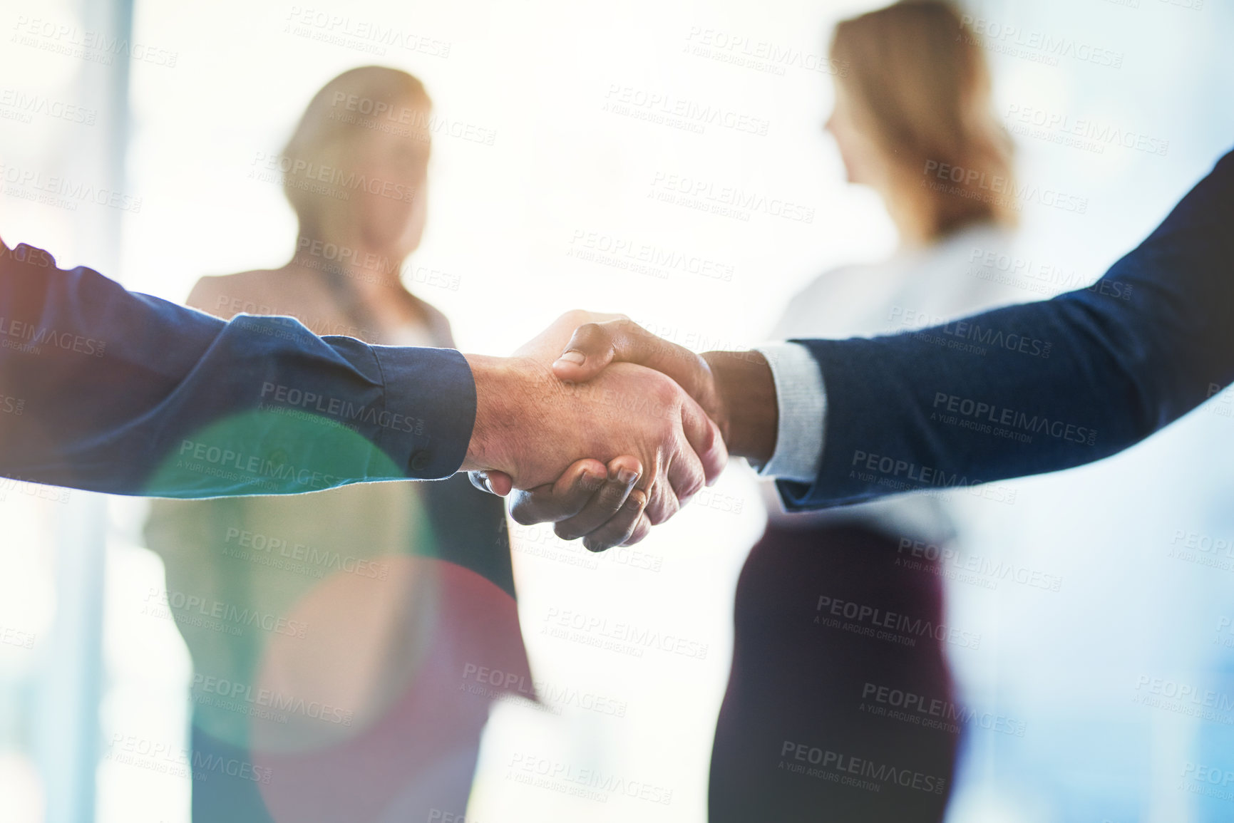 Buy stock photo Cropped shot of two unrecognizable businesspeople shaking hands in an office