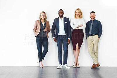 Buy stock photo Shot of well-dressed businesspeople standing against a white background