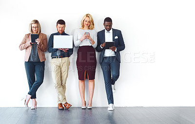 Buy stock photo Shot of a group of entrepreneurs using wireless devices against a white background