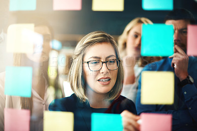 Buy stock photo Woman, ideas and brainstorming with team on glass for schedule, mindmap and planning goals, agenda and timeline. Face of manager, collaboration and sticky note for innovation, training and target 