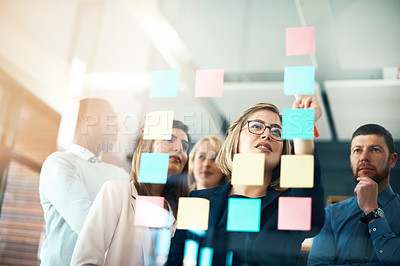 Buy stock photo Planning, innovation and vision business meeting in a modern office, working on a business marketing strategy. Group, team or staff discussing with sticky notes a schedule for future project together