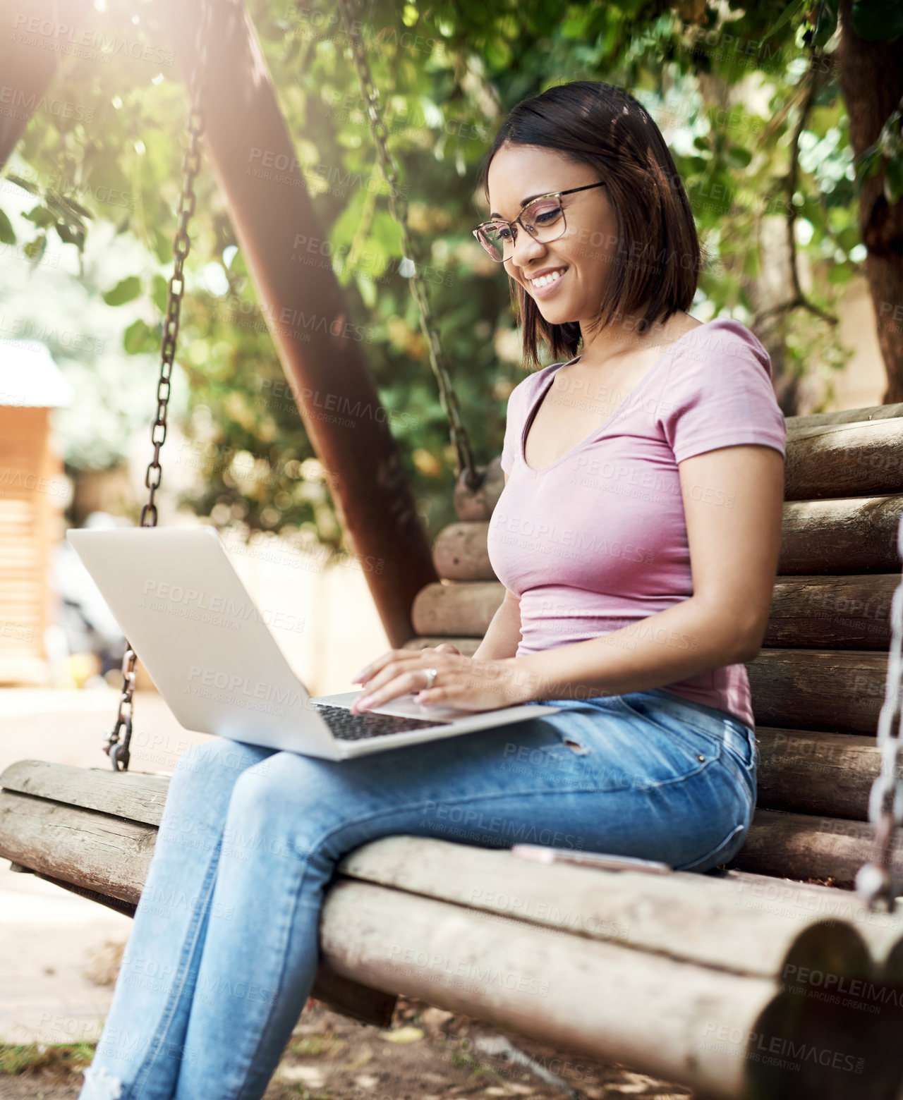 Buy stock photo Cropped shot of an attractive young woman using a laptop outside