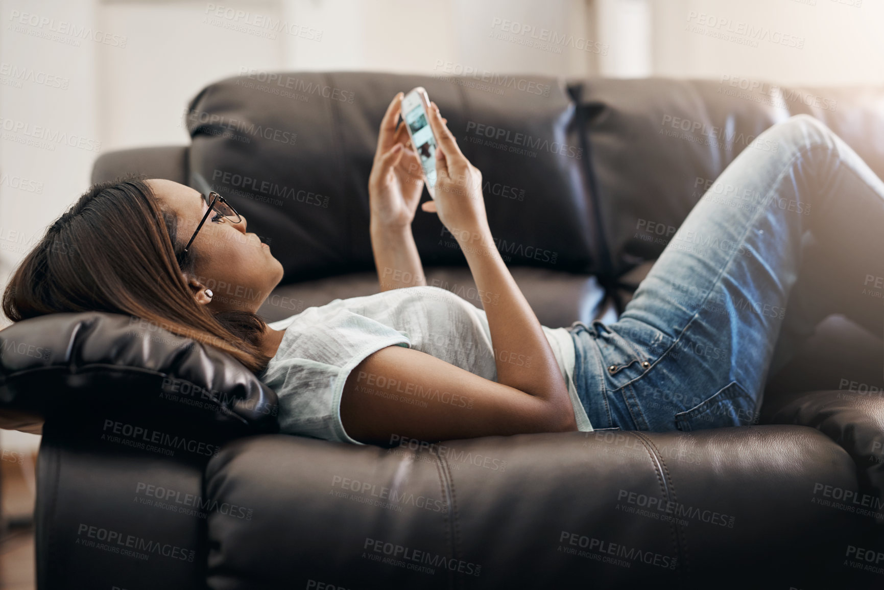 Buy stock photo Cropped shot of a young woman relaxing at home