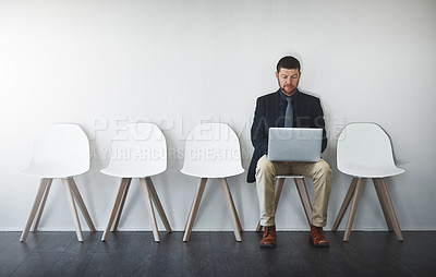 Buy stock photo Hiring, laptop and businessman in waiting room for interview, job application or recruitment on chair. Human resources, typing and person with tech in office for opportunity, onboarding or employment