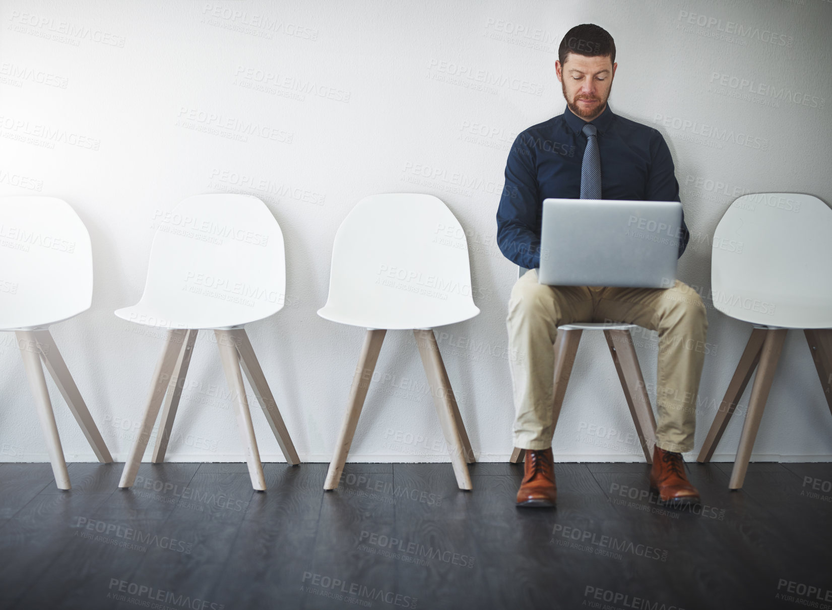 Buy stock photo Studio shot of a businessman waiting in line against a white background