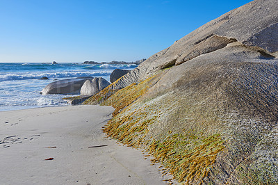 Buy stock photo Rocks, sand and beach shore for freedom, holiday trip and tranquility in tropical island of New Zealand. Boulders, peace and travel to sea waves in nature, ocean vacation and sustainable adventure