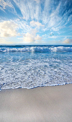 Buy stock photo Sandy beach, sea, blue sky with clouds and copy space. Scenic seascape view of ocean waves washing on shore sand in a tropical resort with copyspace. Travel overseas, tourism abroad on summer holiday