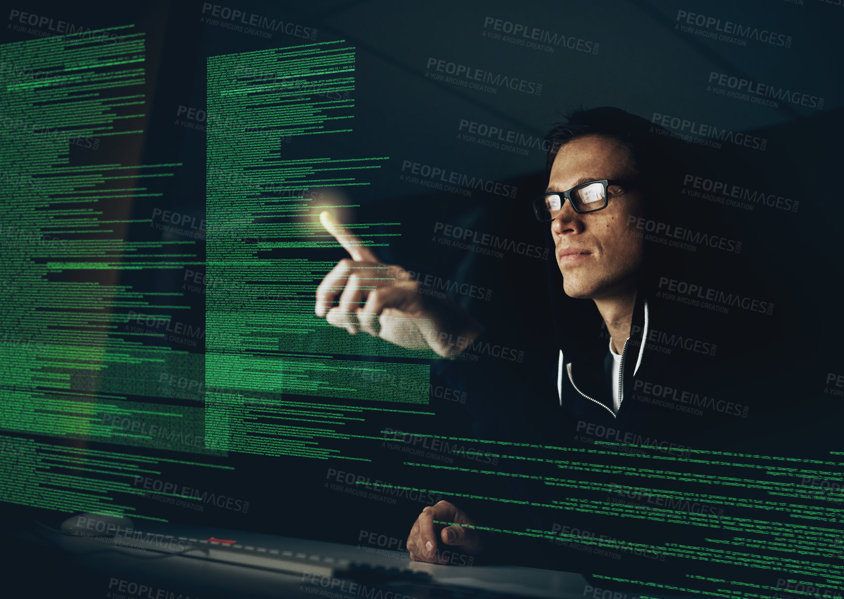 Buy stock photo Cropped shot of a young hacker cracking a computer code in the dark