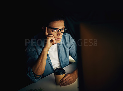 Buy stock photo Cropped shot of a young man working late in his office