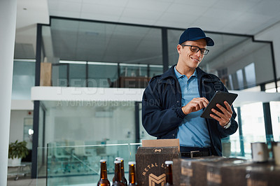 Buy stock photo Cropped shot of a handsome young man taking inventory of items that he has to deliver to customers