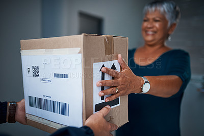 Buy stock photo Cropped shot of a package being delivered to a senior woman