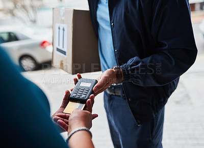 Buy stock photo Cropped shot of an unrecognizable man delivering a package to a customer and receiving payment with a card