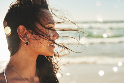 Buy stock photo Shot of a beautiful young woman enjoying a summer’s day at the beach