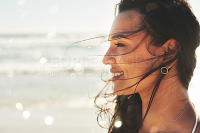 Buy stock photo Shot of a beautiful young woman enjoying a summer’s day at the beach