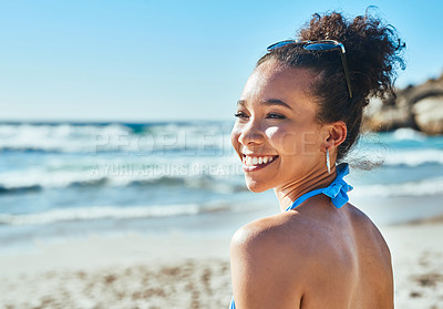 Buy stock photo Shot of a beautiful young woman enjoying a summer’s day at the beach