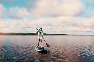 Buy stock photo Woman, lake and serious for paddleboarding on holiday with adventure, recreation and fun in Bali. Female person, confident and travel for summer vacation, journey and break to relax with fitness