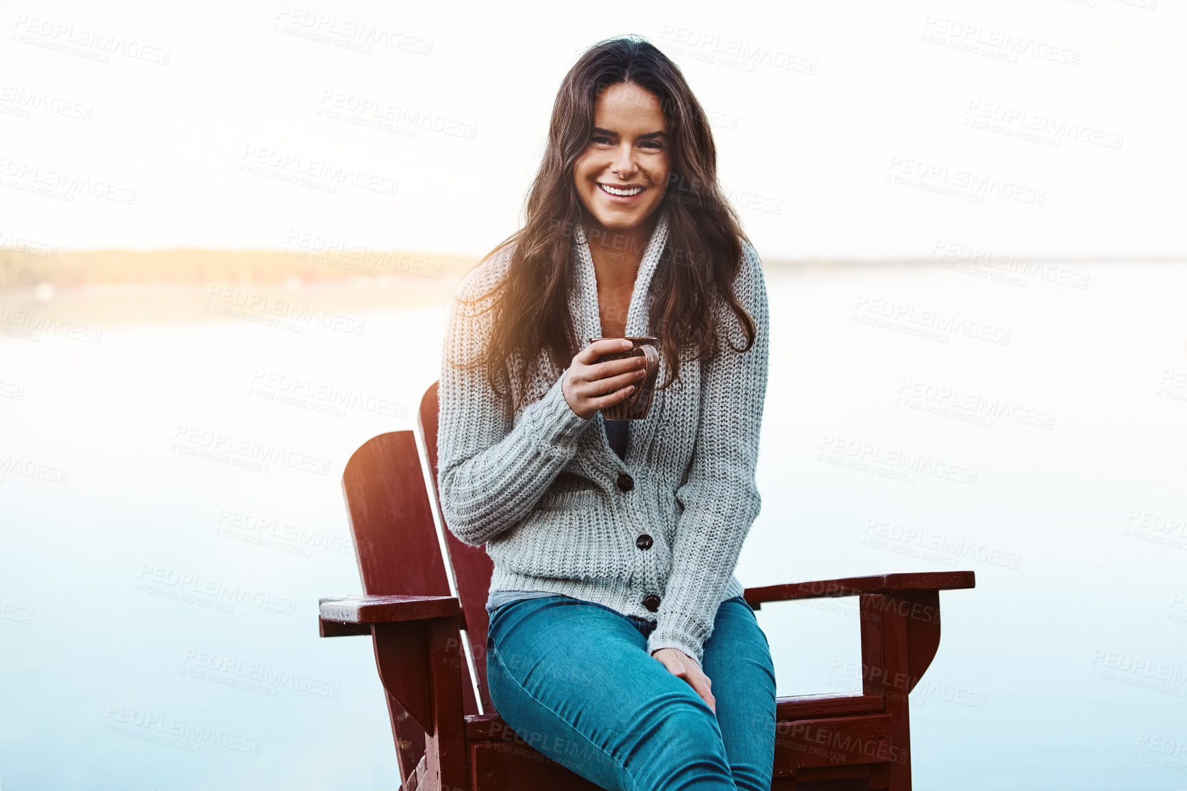 Buy stock photo Portrait, coffee and woman with happy in lake, warm and smile for vacation, outdoor and relax in nature. Holiday, chair and scenery with peace in Michigan, rest and tea in countryside for weekend