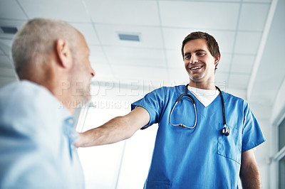 Buy stock photo Low angle shot of a male nurse caring for a senior patient