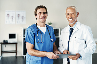 Buy stock photo Portrait of two medical practitioners using a digital tablet in a hospital