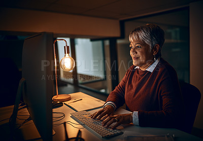 Buy stock photo Shot of a mature businesswoman working late in an office