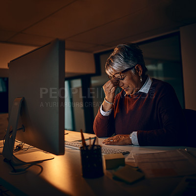 Buy stock photo Stress, night and mature businesswoman at desk by computer for fatigue, overtime or project deadline in office. Headache, publishing agency and employee for exhausted, burnout or eye strain in dark