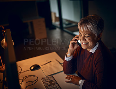 Buy stock photo Night, mature woman and phone call in office for business, communication and contact. Dark, happy and lady at desk with tech, scheduling and chatting on mobile for funny story or gossip on late shift