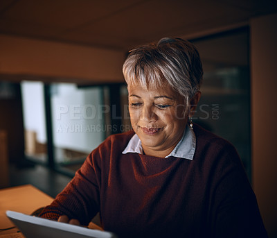 Buy stock photo Research, tablet and mature business woman check email, update and overtime in startup at night. Reading, technology and manager or news editor working on article, story review or creative feedback