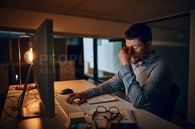 Buy stock photo Stress, night and business man at desk by computer for fatigue, overtime or project deadline in office. Tired, publishing agency and employee for exhausted, reading online report or decision in dark