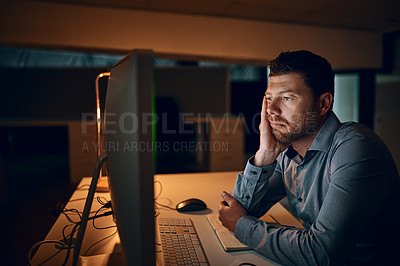 Buy stock photo Bored, reading and business man at desk by computer for fatigue, overtime or project deadline at night. Tired, publishing agency and male employee for exhausted, online report or decision in office