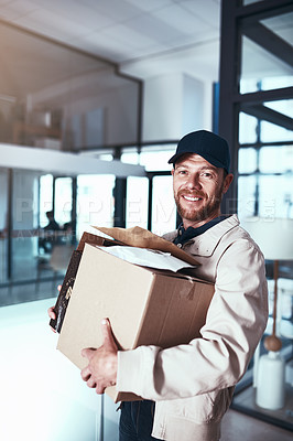 Buy stock photo Portrait of a cheerful young man holding two boxes inside of a office building during the day