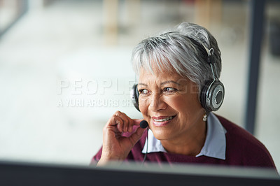 Buy stock photo Shot of a mature woman working on a computer in a call centre