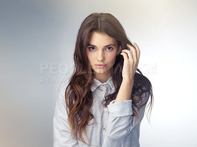 Buy stock photo Studio shot of a beautiful young woman posing against a gray background