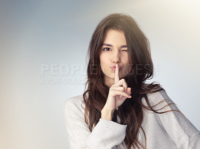 Buy stock photo Woman, studio portrait and secret with finger on mouth for beauty deal, wink eye or icon for silence by background. Isolated model girl, cosmetics flirt or hand sign with emoji, whisper and makeup