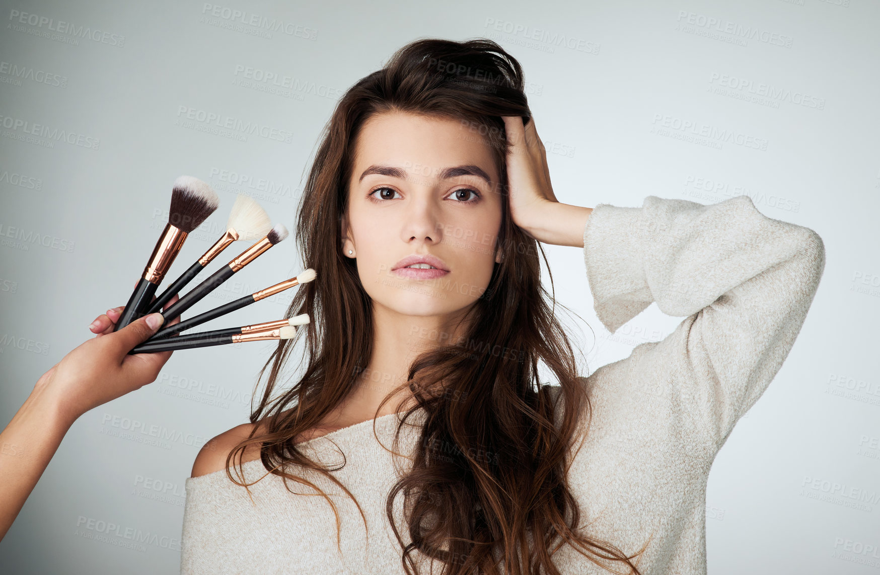 Buy stock photo Makeup brush, face and beauty of a woman in studio with a natural glow. Portrait of a female model person on a grey background and hands for cosmetology transformation, powder cosmetics and skin care