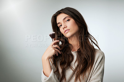 Buy stock photo Face, makeup brush and beauty of a woman in studio with a natural glow. Portrait of a female model person on a grey background with mockup for cosmetology, powder cosmetics and facial skin care