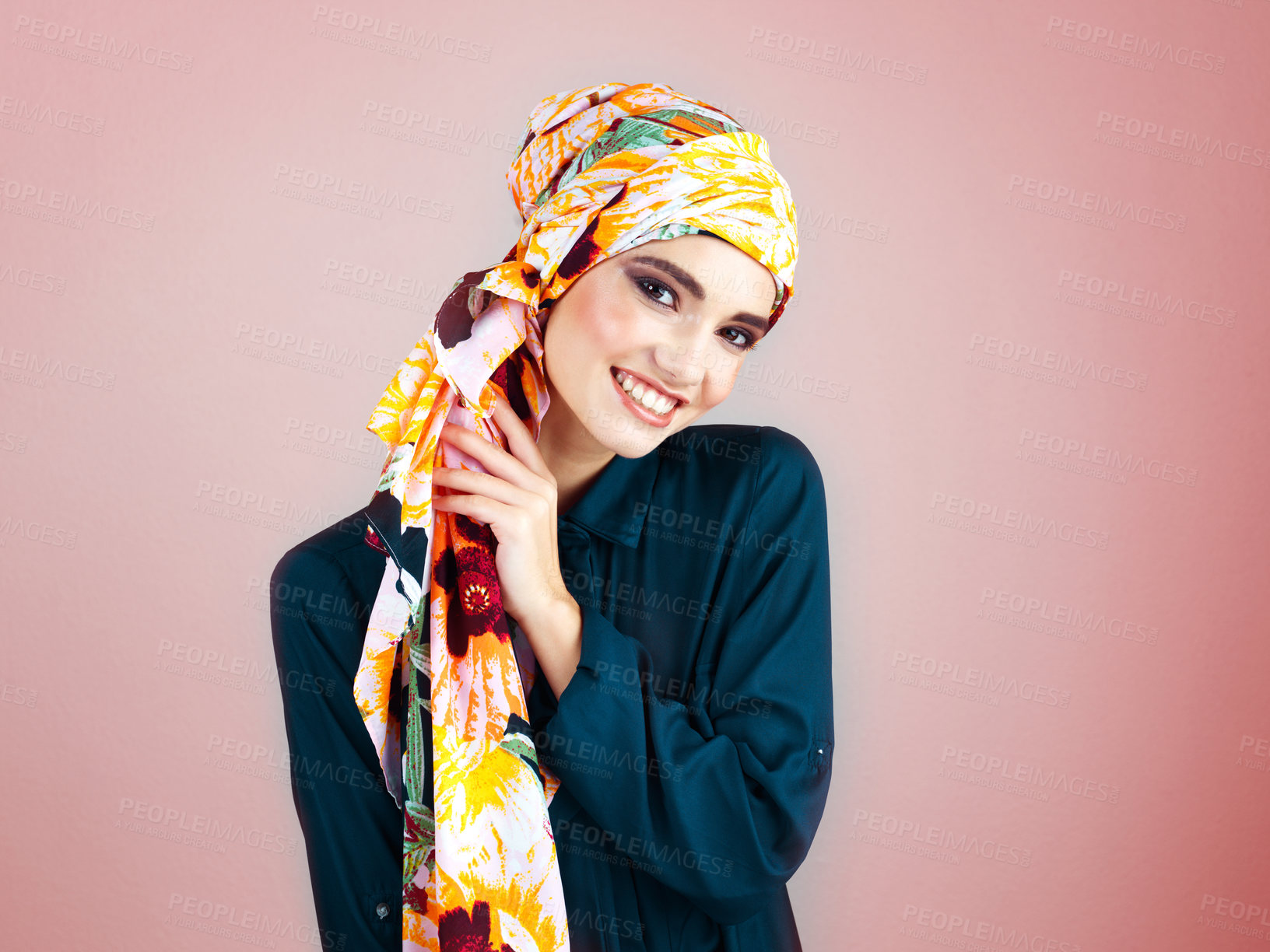 Buy stock photo Studio portrait of a confident young woman wearing a colorful head scarf while posing against a pink background