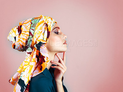 Buy stock photo Studio shot of a confident young woman wearing a colorful head scarf while posing against a pink background