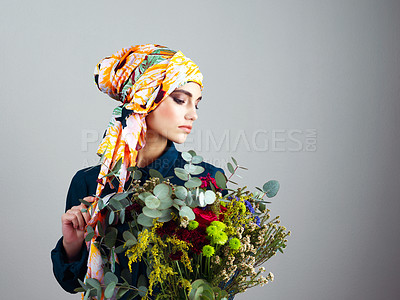 Buy stock photo Woman, flowers and bouquet for beauty in studio, spring or nature with headscarf by background. Person, girl or model for floral plants, leaves or thinking with makeup, style or sustainable fashion