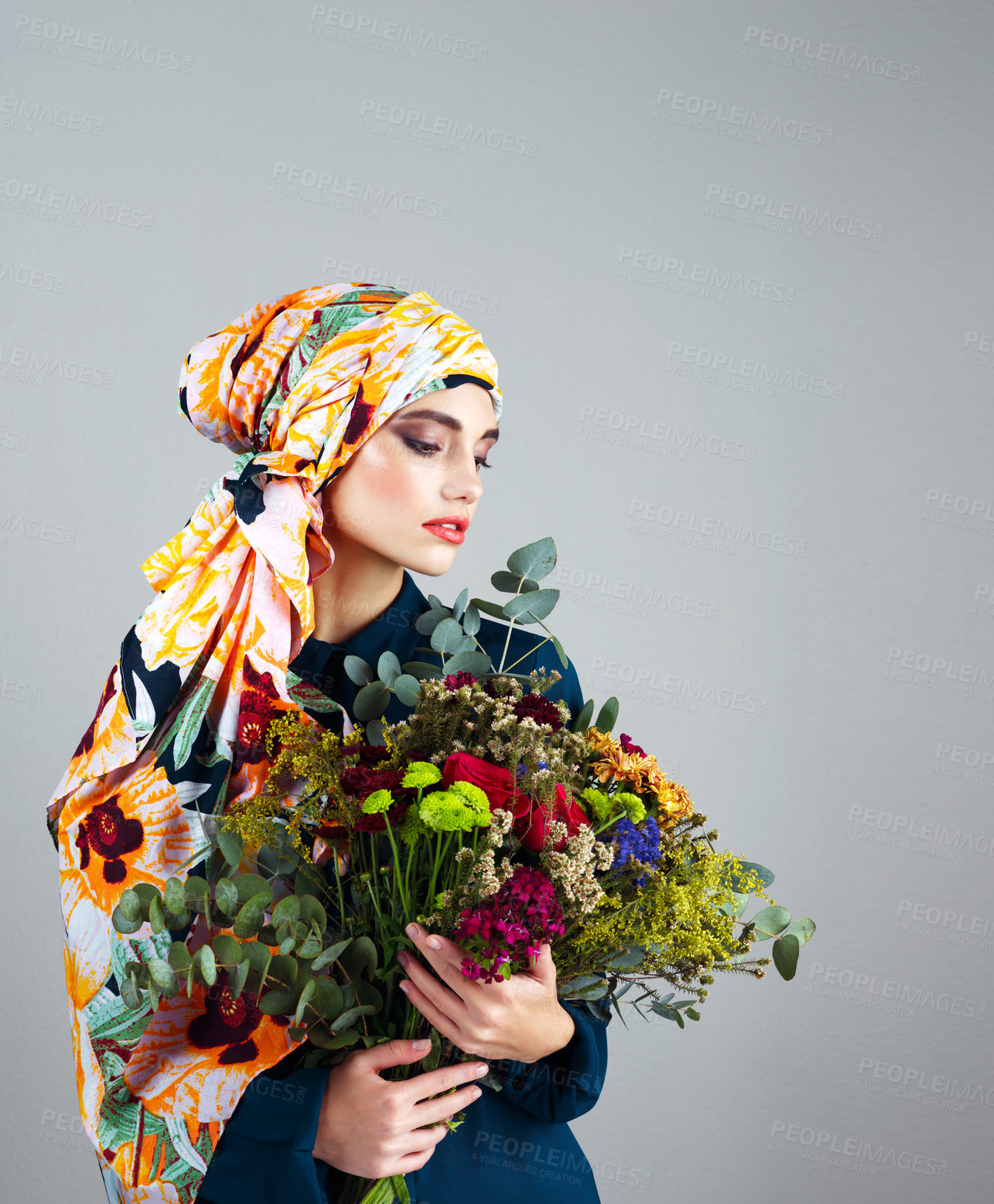 Buy stock photo Woman, turban and bouquet of flowers in studio, spring or nature with thinking by background. Person, girl or model for floral plants, leaves and headscarf with makeup, style and sustainable fashion