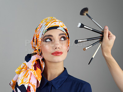 Buy stock photo Muslim girl, brush and beauty in studio for makeup, many or decision with process for results by background. Model, woman or choice with tools for application, turban or transformation with cosmetics