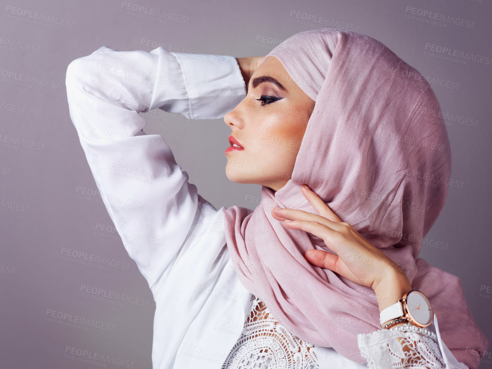Buy stock photo Studio shot of a confident young woman wearing a colorful head scarf while posing against a grey background