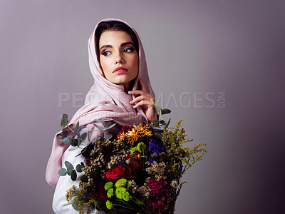 Buy stock photo Muslim woman, flowers and bouquet for beauty in studio, spring or nature with headscarf by background. Person, girl and model with plants, leaves or thinking with makeup, style or sustainable fashion