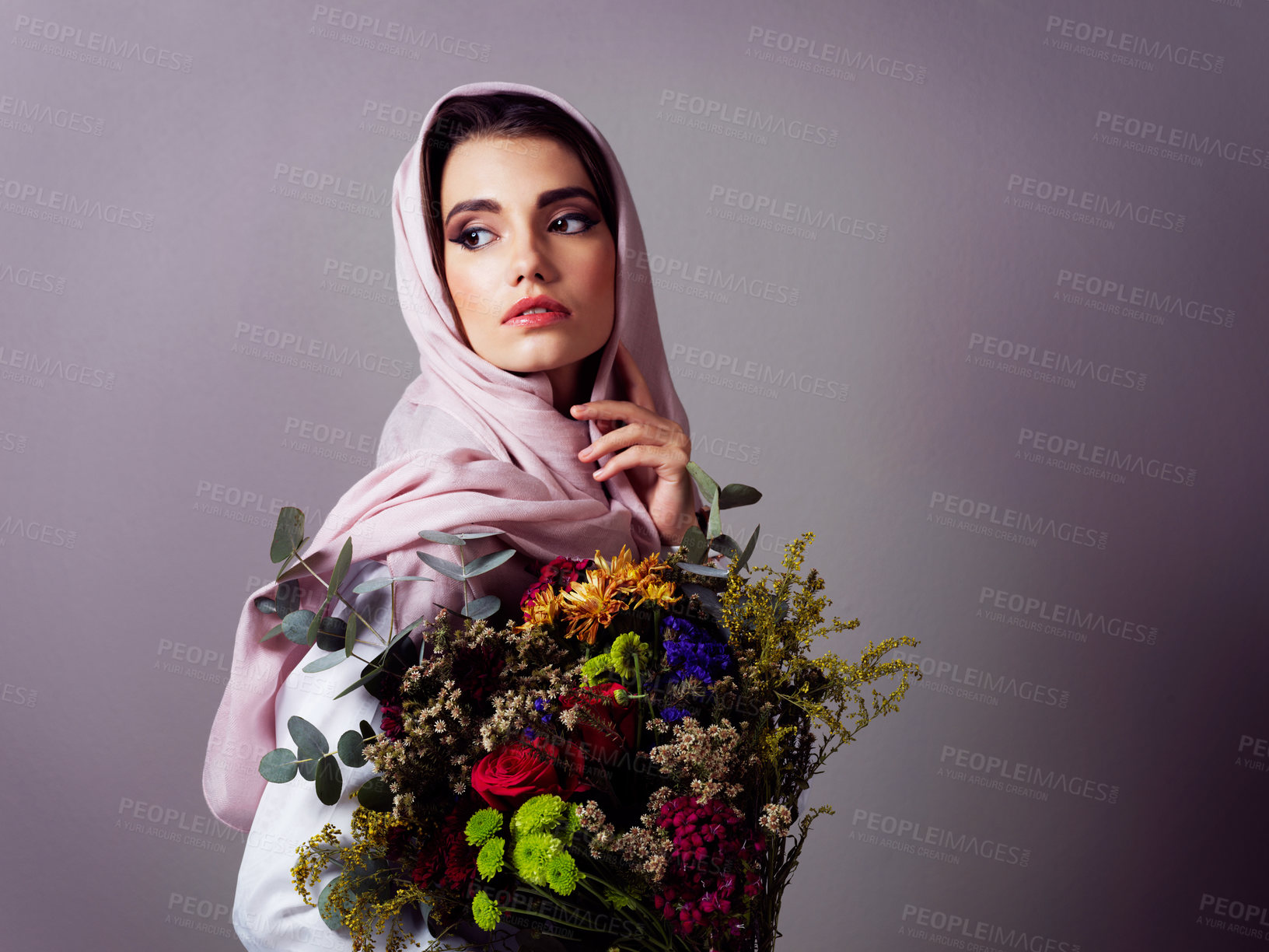 Buy stock photo Muslim woman, flowers and bouquet for beauty in studio, spring or nature with headscarf by background. Person, girl and model with plants, leaves or thinking with makeup, style or sustainable fashion