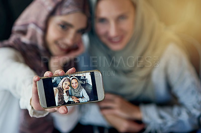 Buy stock photo Muslim women, friends and selfie with cellphone, smile and happiness for post on blog, web or social media. Happy islamic woman, group and smartphone for photography, profile picture or memory on app