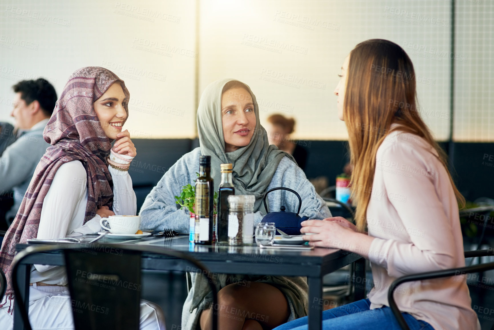 Buy stock photo Friends, smile and Muslim women in cafe, bonding and talking together. Coffee shop, happy and Islamic girls, group or people chat, conversation and discussion for social gathering in restaurant.