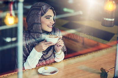 Buy stock photo Shot of a young woman having a cup of coffee in a cafe